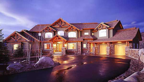 House plan exterior of a large, multi-story residence featuring stone accents, exposed timber framing, and a prominent covered entryway.