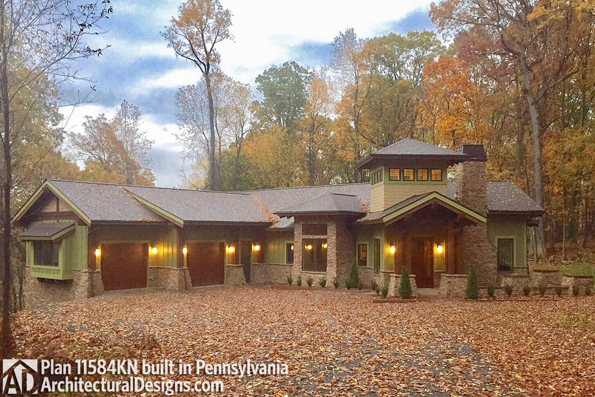 Plan 11584KN house plan exterior with stone accents, covered entry, multi-car garage, and prominent chimney.