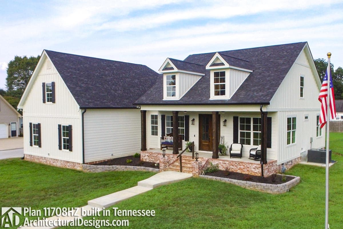Modern Farmhouse house plan exterior with covered porch, dormers, board and batten siding, and brick accents.