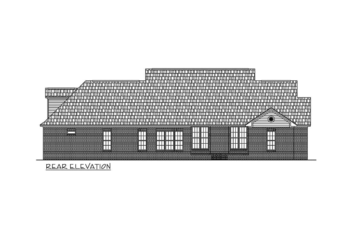 Rear elevation drawing of a single-story house plan with multiple rooflines, brick facade, and varied window arrangements.