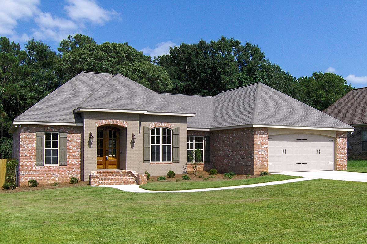 House plan exterior. One-story house with brick facade, gabled roof, arched entryway, and attached garage.