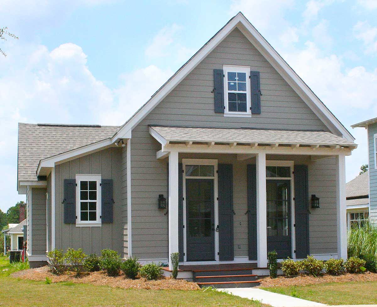 House plan exterior: one-story home with a covered front porch, two front doors, gable, and dormer.