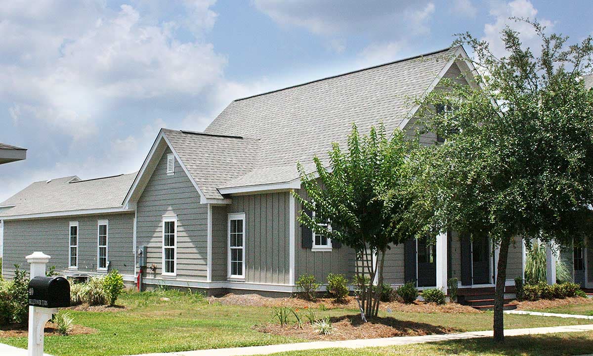 House plan exterior with mixed siding, gabled rooflines, and multiple dormers.