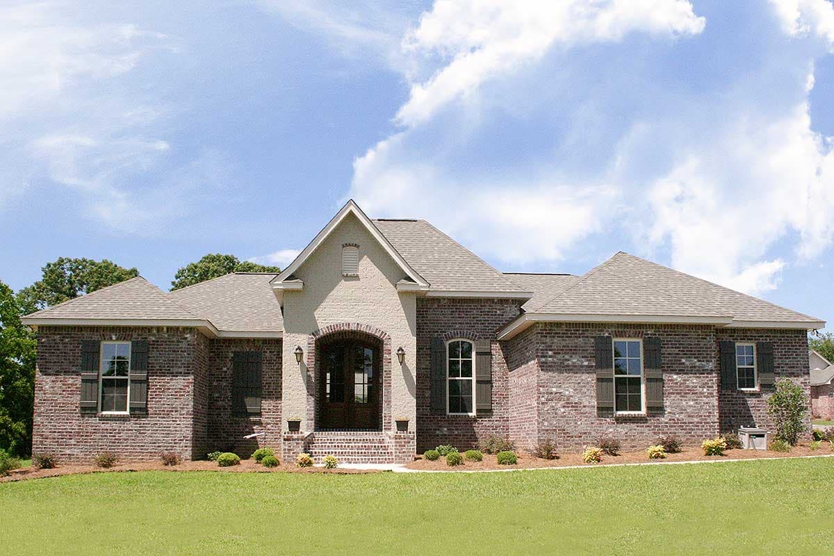 House plan exterior: One-story brick home with arched entry, gable roof, dormers, and shutters.