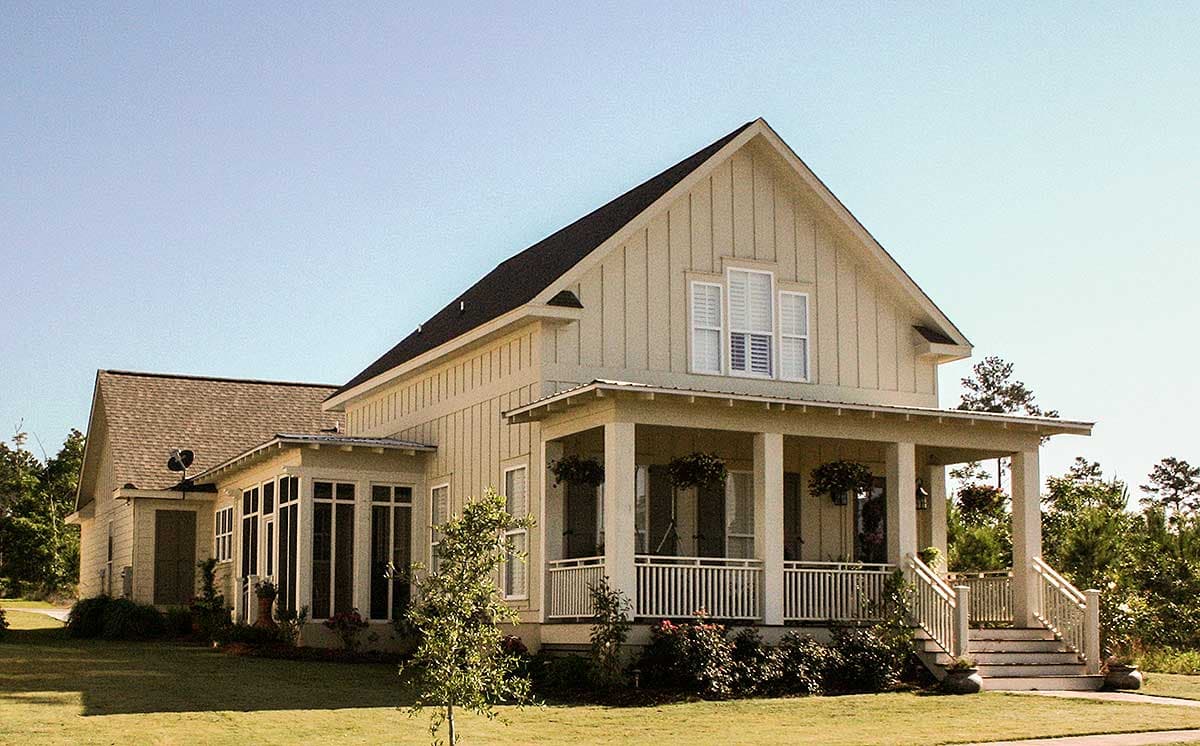 Modern Farmhouse house plan exterior with a large wrap-around porch, gables, and a sunroom.