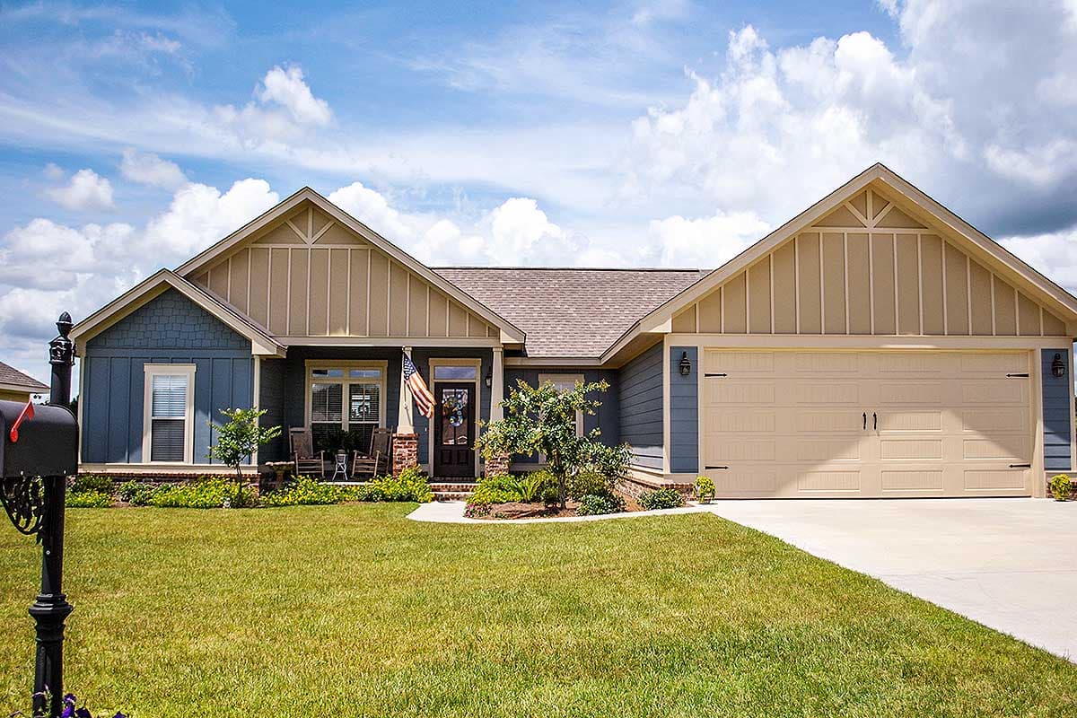House plan exterior: Ranch style, one story, blue siding, tan gables with board and batten, covered front porch, attached two-car garage.