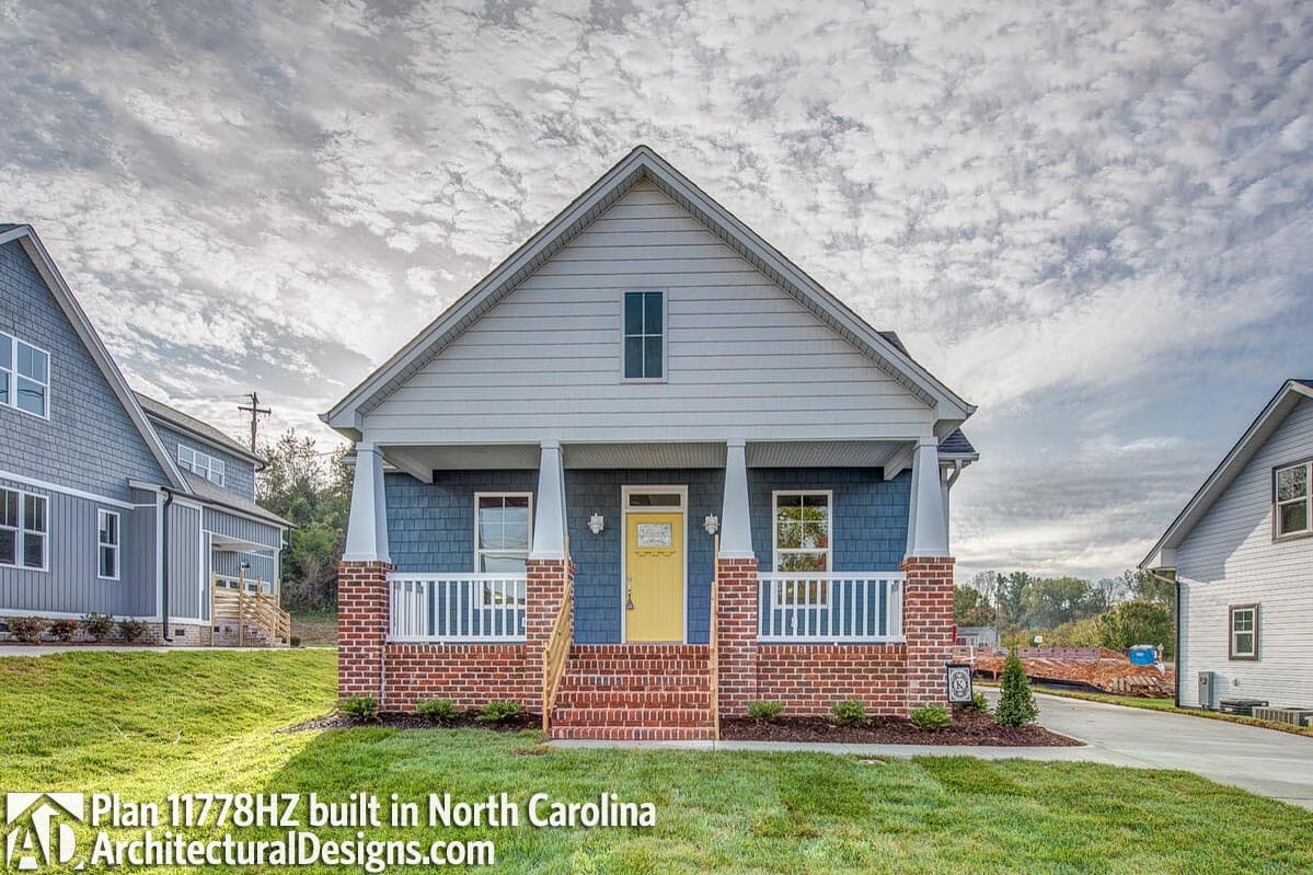 House plan exterior: Traditional style, one story, front porch with columns, gabled dormer, brick and shingle siding.