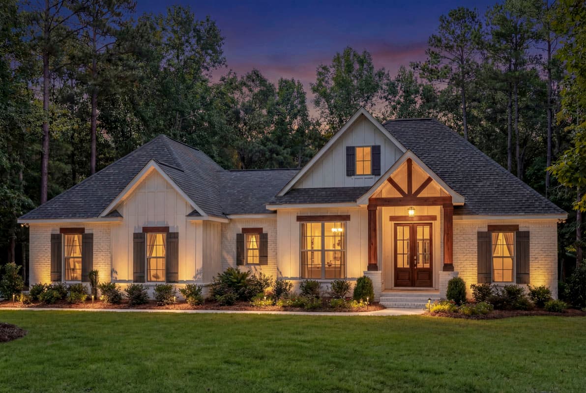 House plan exterior: Modern Farmhouse style, one story, white brick, board and batten siding, gabled roof, decorative gable brackets, covered entry.
