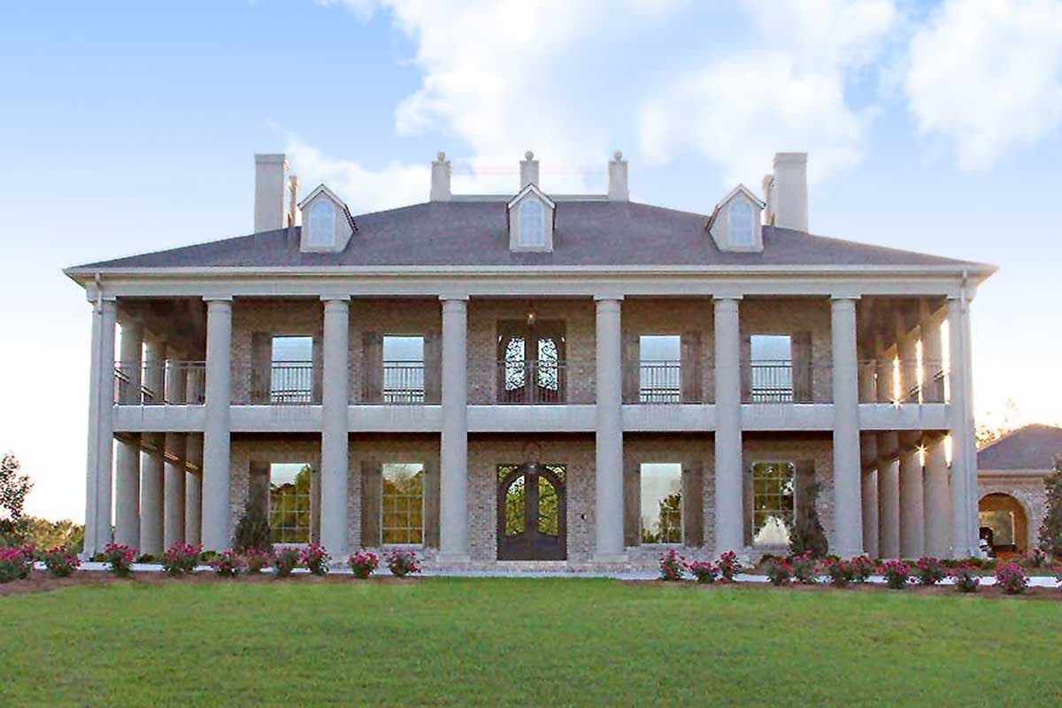 House plan exterior featuring a two-story Colonial style with columns, dormers, and a covered porch. Balconies are on the second story.