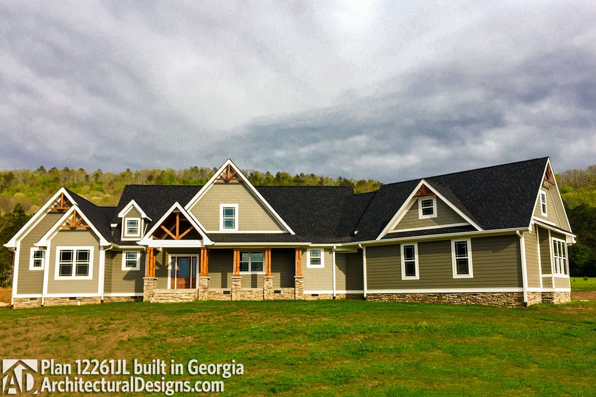 Modern Farmhouse house plan exterior, one story, with prominent gables, decorative truss details, and a covered front porch.
