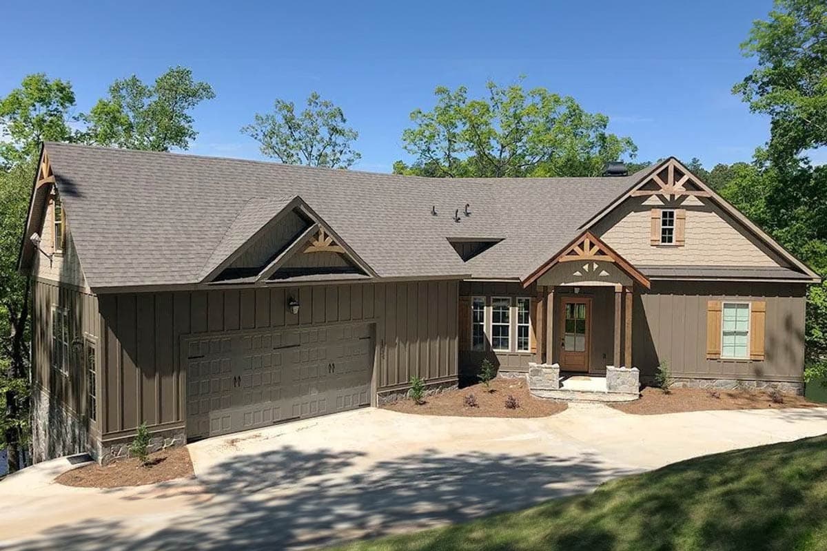 Craftsman house plan exterior with gables, exposed rafter tails, covered porch, and attached garage.