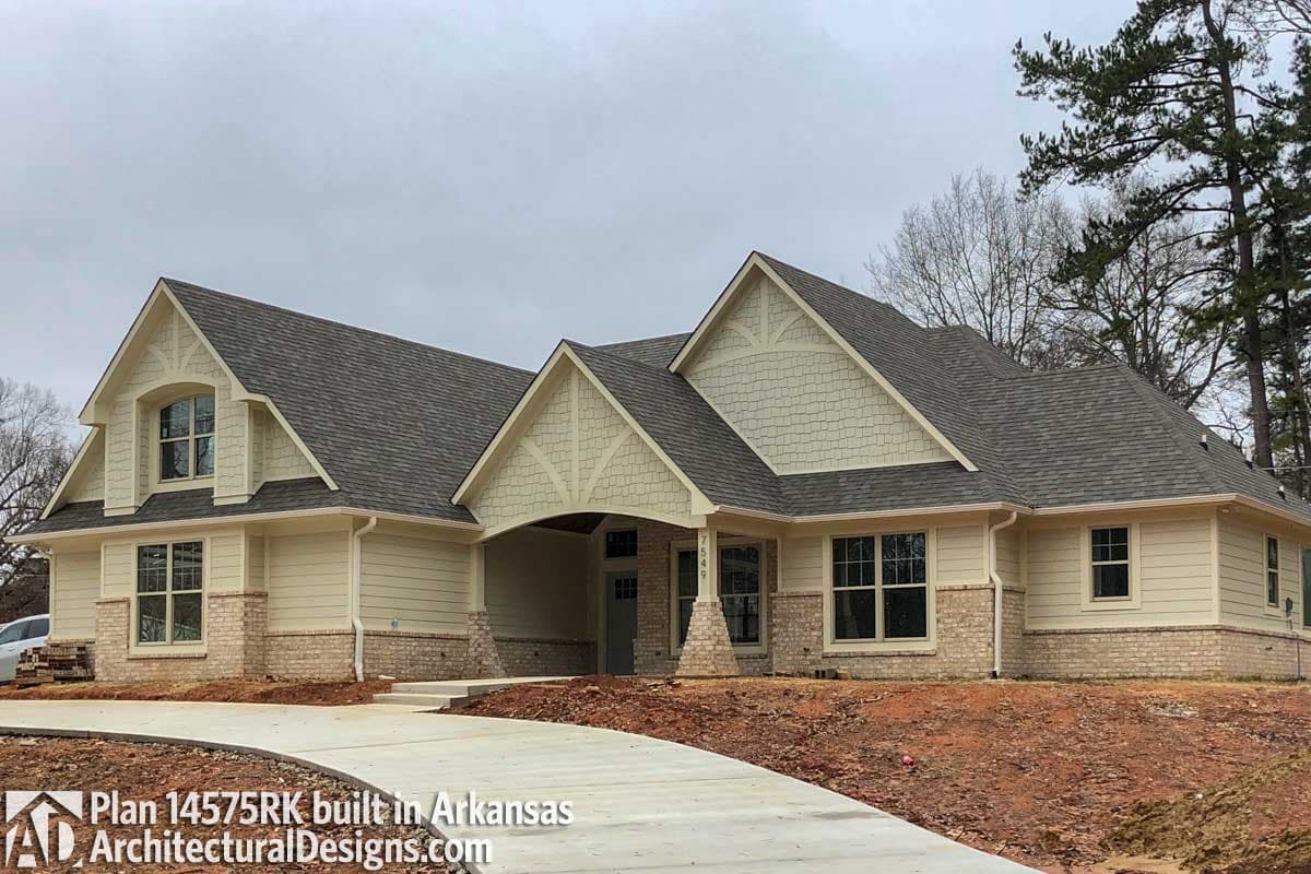 House plan exterior with gables, dormers, and brick and shingle siding.