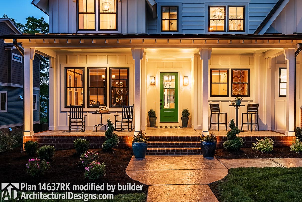 Modern Farmhouse house plan exterior with wide covered porch, white board and batten siding, and a green front door.