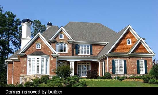 House plan exterior: Two-story brick residence with multiple gables, dormers, arched windows, and a covered entry porch.