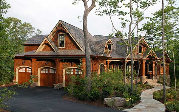 House plan exterior: Craftsman style, two stories, with a three-car garage, prominent gables, and a covered front porch.