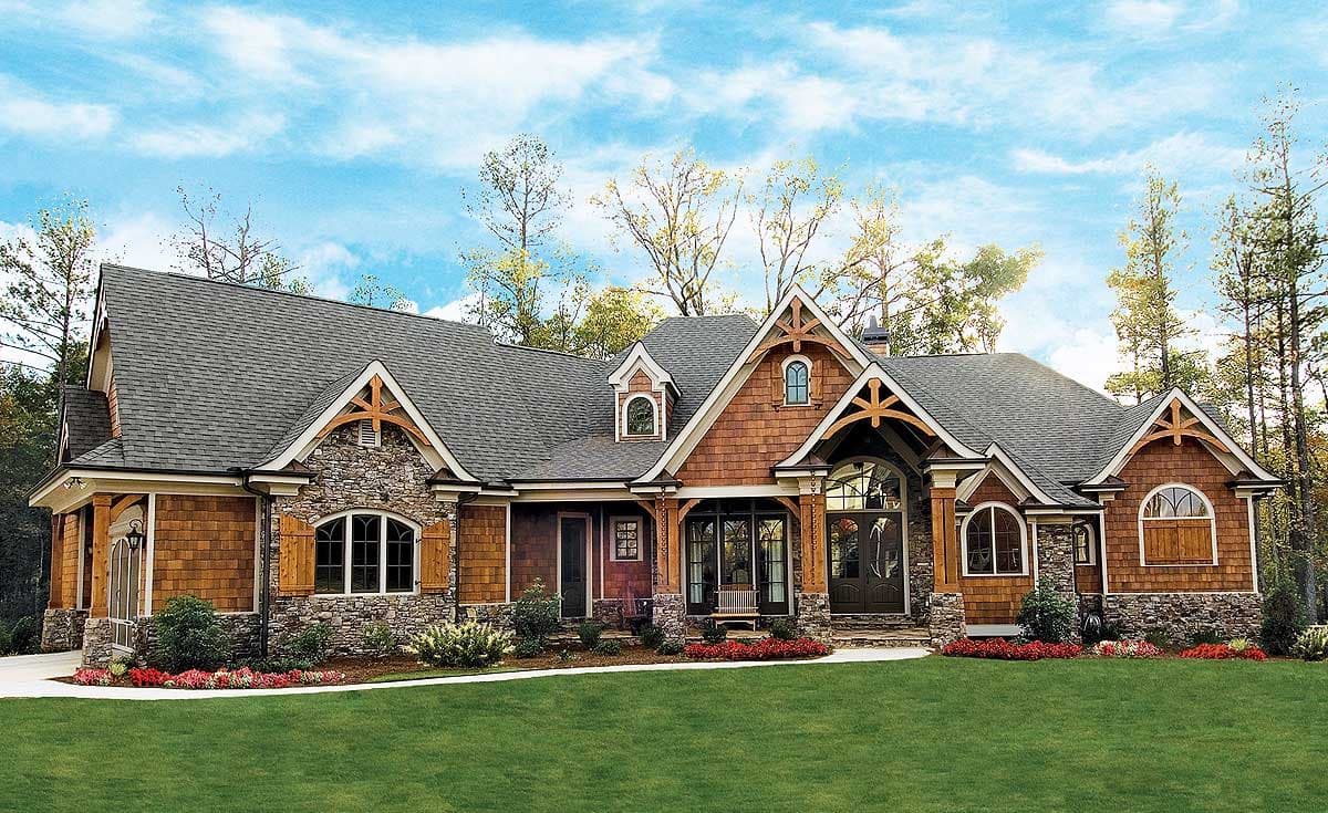 House plan exterior with stone and shingle siding, multiple gables, dormers, and arched windows.
