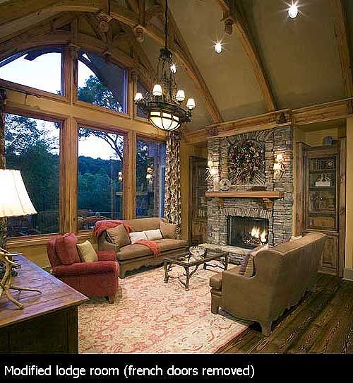 Great room with vaulted ceilings, exposed beams, stone fireplace, and large window wall.