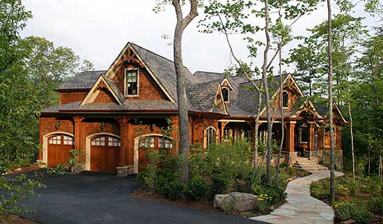 House plan exterior featuring a multi-story wood-clad structure with a three-car garage, prominent gables, and a covered porch.