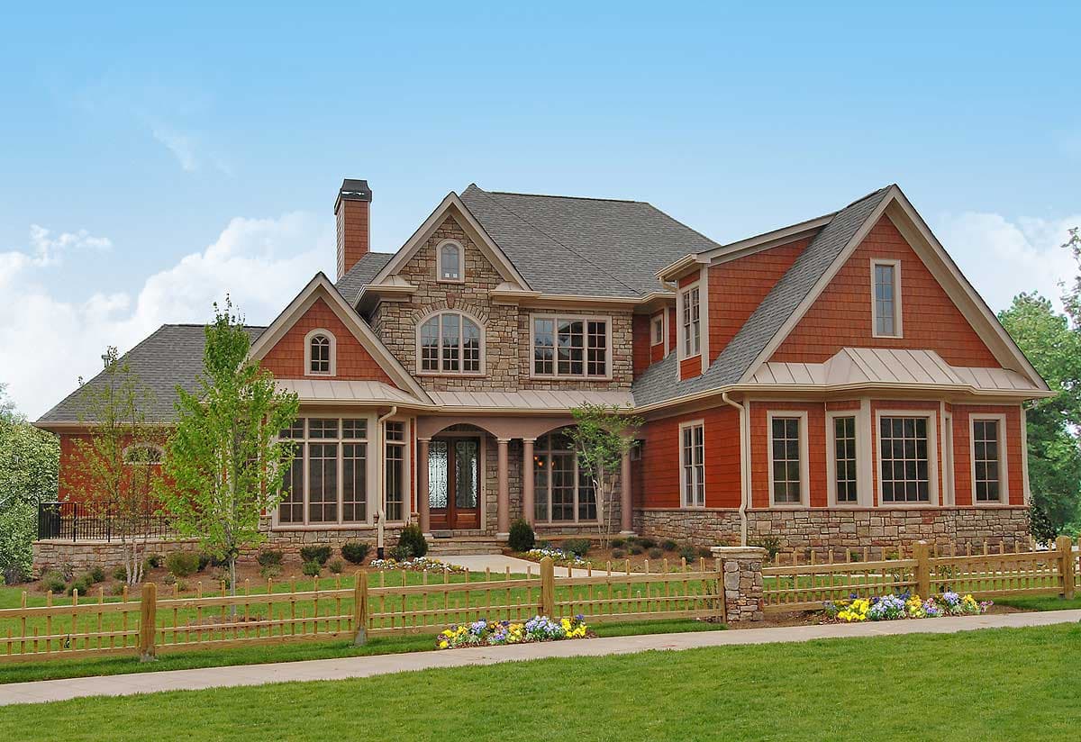 House plan exterior: Two-story home with stone accents, arched windows, shingle siding, and a covered entry with columns.