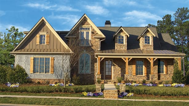 Craftsman house plan exterior with stone accents, gabled dormers, a covered porch with wooden columns, and metal roof sections.