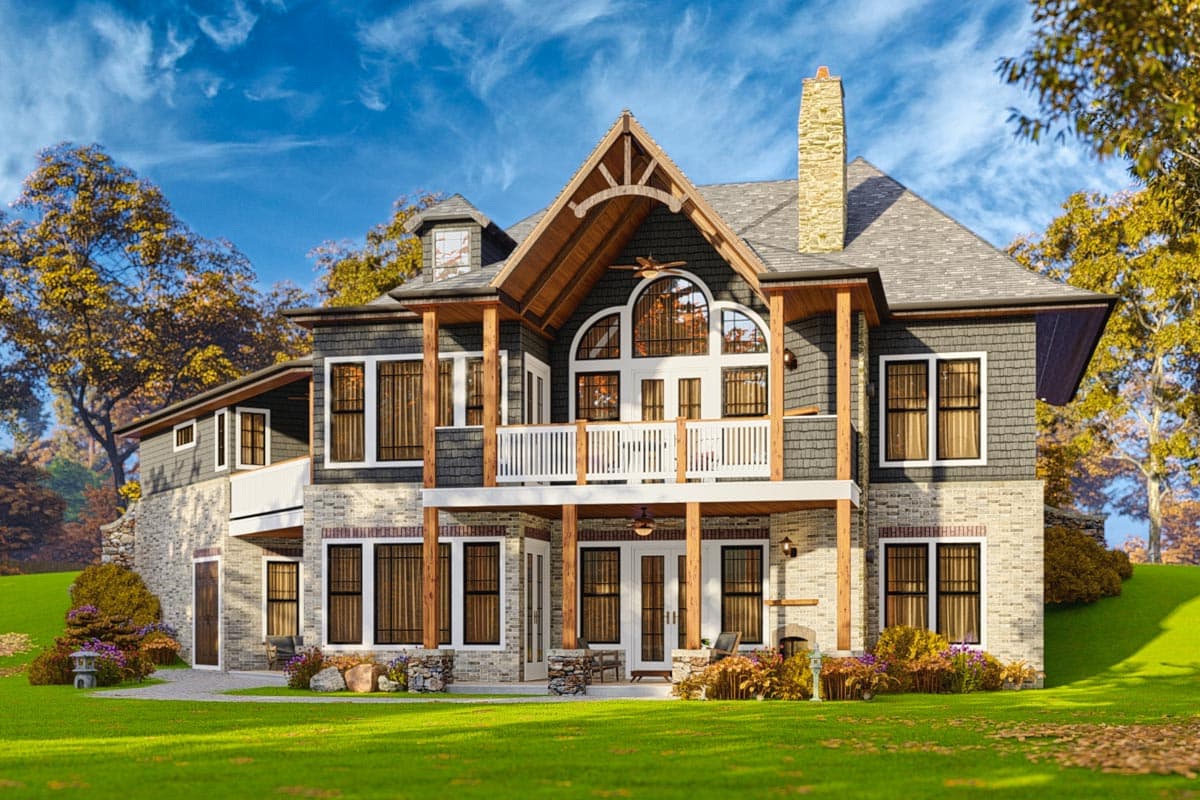 House plan exterior: Craftsman style, multiple stories, prominent gables, stone chimney, and covered porch.