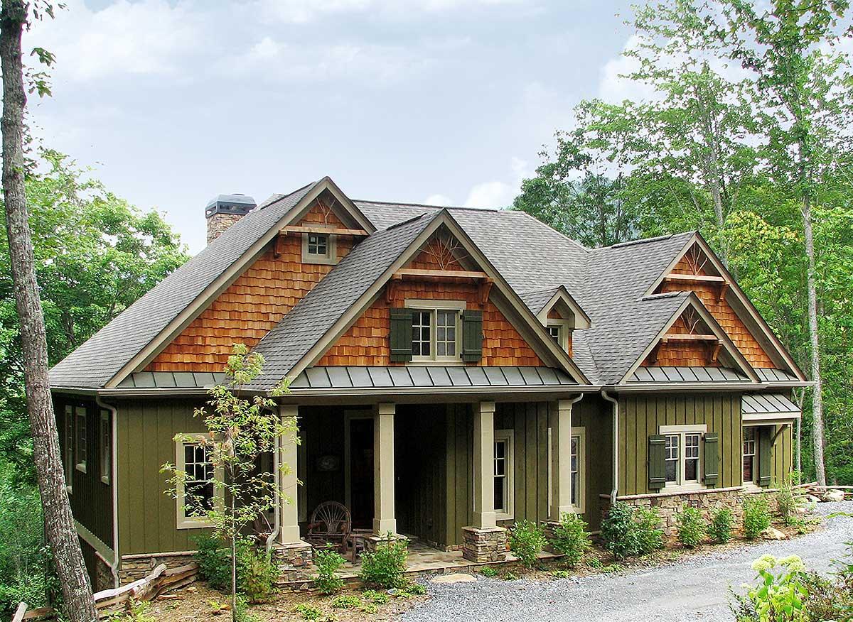 Craftsman house plan exterior with cedar shakes, stone accents, a covered porch with square columns, and multiple gables.