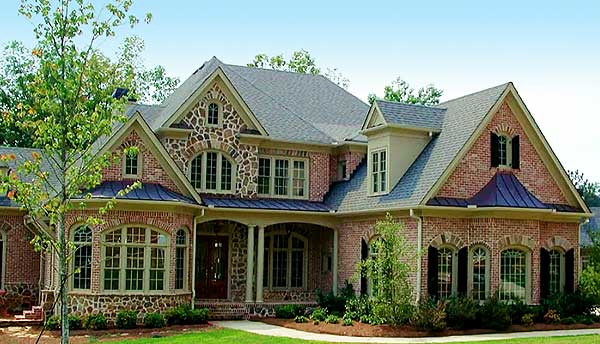House plan exterior featuring brick and stone facade, multiple gables, arched windows, dormers, and a covered porch.