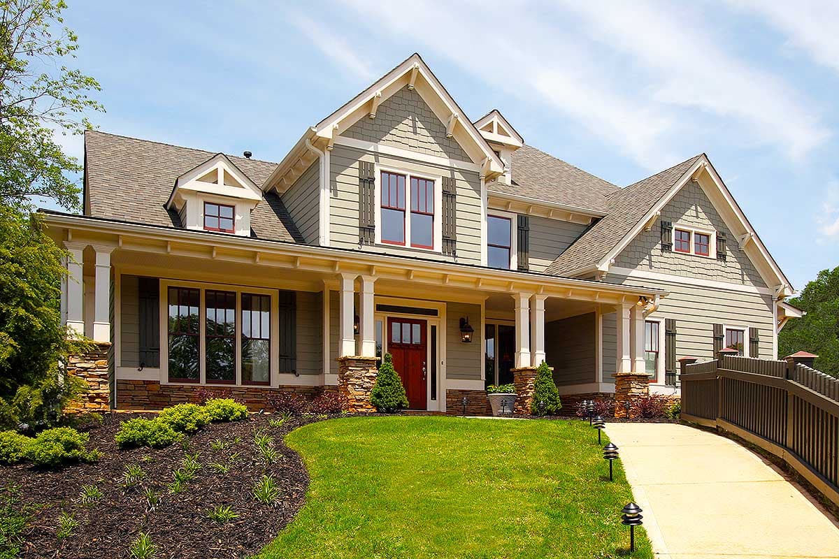 House plan exterior. Two-story Craftsman home with a front porch, gabled rooflines, dormers, and stone accents at the foundation.