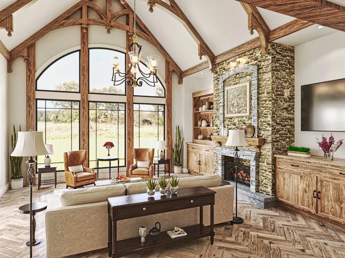 Great room with vaulted beamed ceiling, stone fireplace, and wall of arched windows.