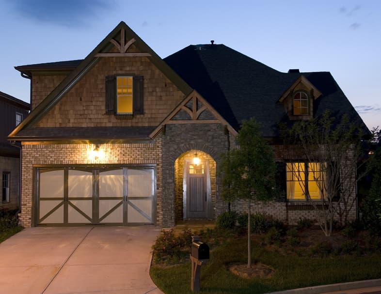 Craftsman style house plan exterior with gabled dormers, stone and shingle siding, and a two-car garage.