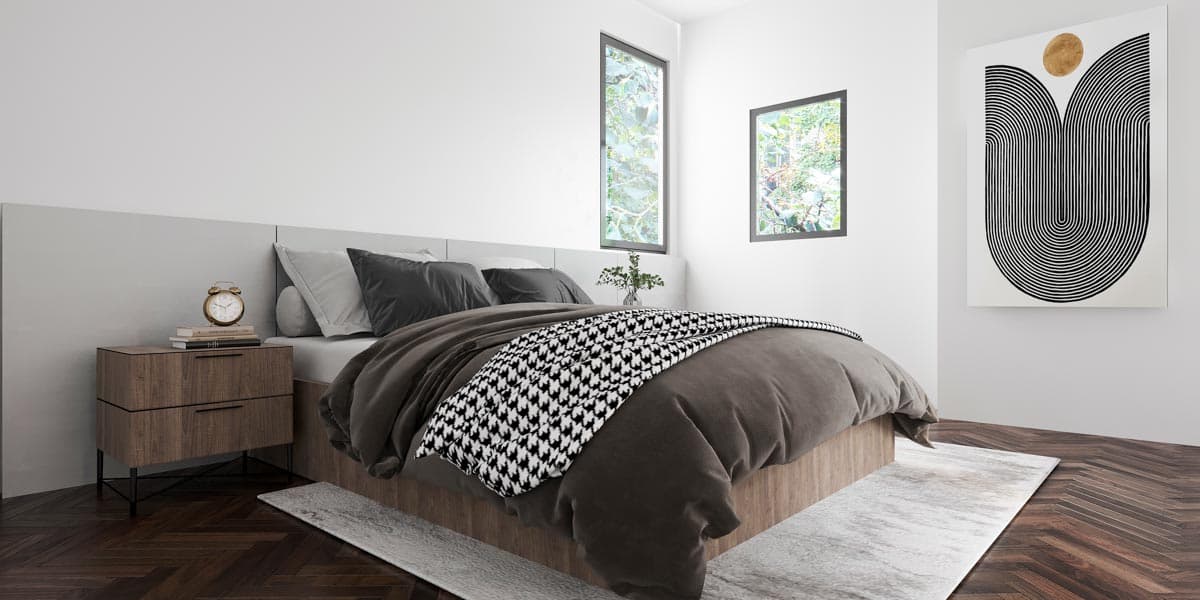 Modern bedroom with king-size bed, dark wood nightstand, two vertical windows, and abstract wall art.