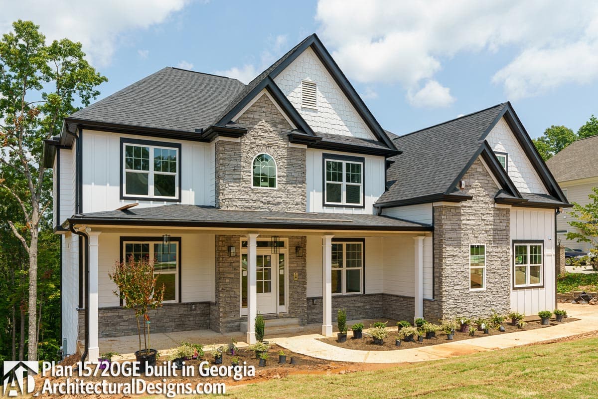 House plan exterior: Two-story Modern Farmhouse with stone and board-and-batten siding, wraparound porch, and multiple gables.
