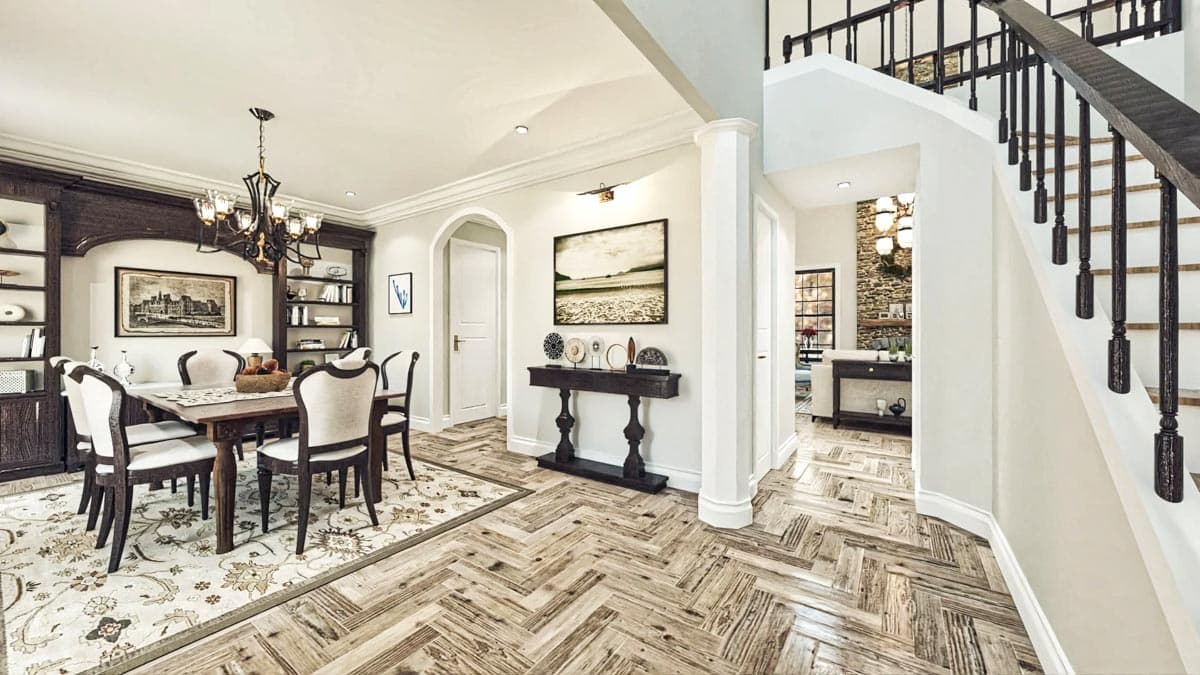 Dining room with built-in bookshelves, dark wood table, upholstered chairs, and herringbone wood floors, adjacent to a staircase.