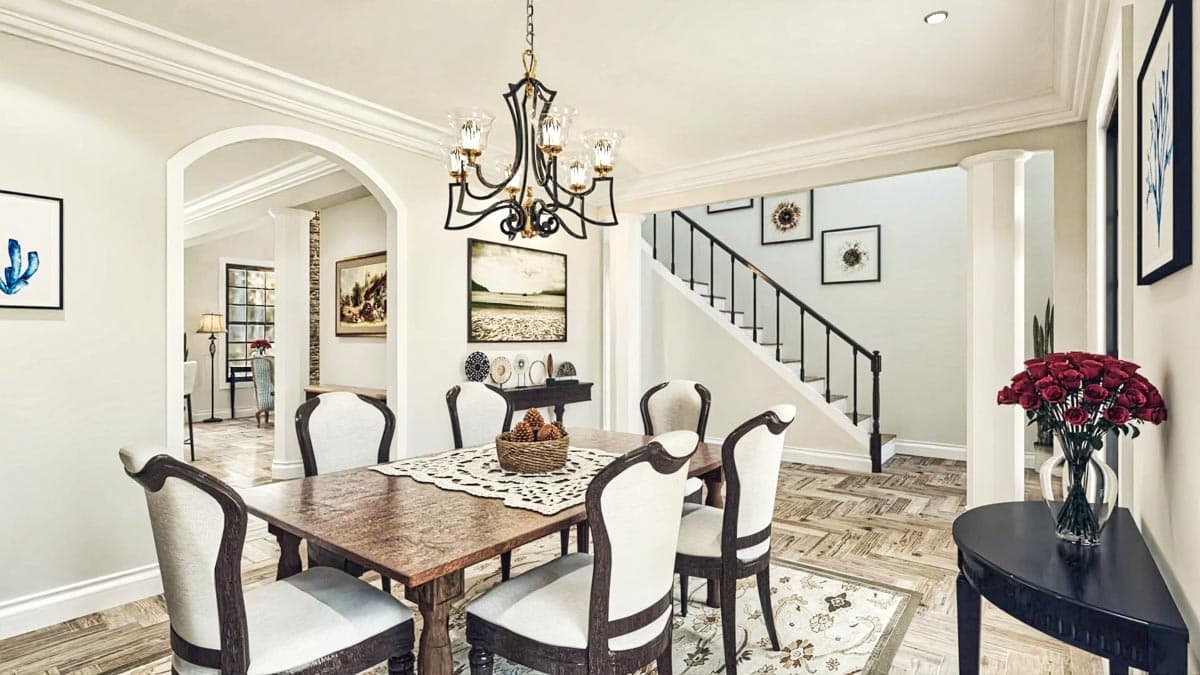 Dining room with wood table, upholstered chairs, and view of staircase and arched entryway.