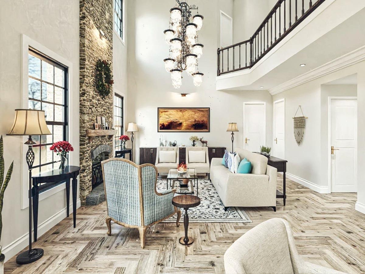 Great room with vaulted ceiling, stone fireplace, upper-level balcony, and natural light from large windows.