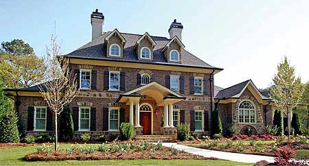House plan exterior with brick facade, arched dormers, covered portico with columns, and large arched window.