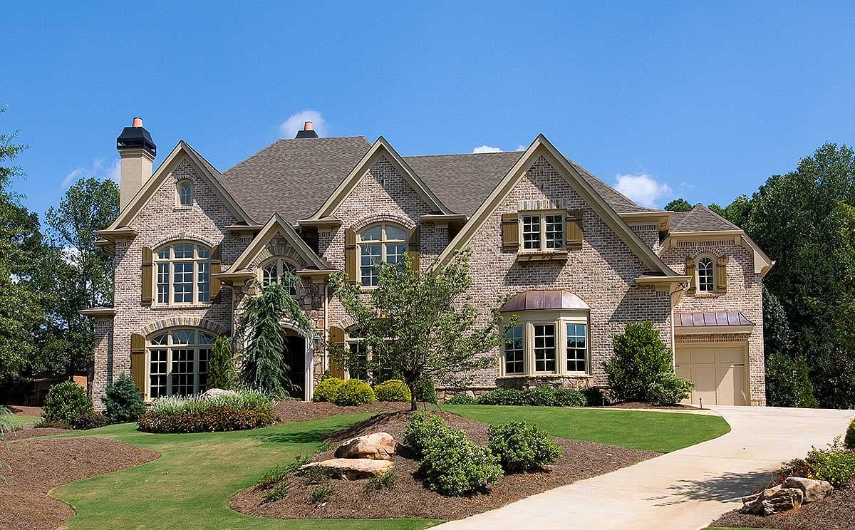 Two-story brick house plan exterior with multiple gables, arched windows, bay window, and attached two-car garage.