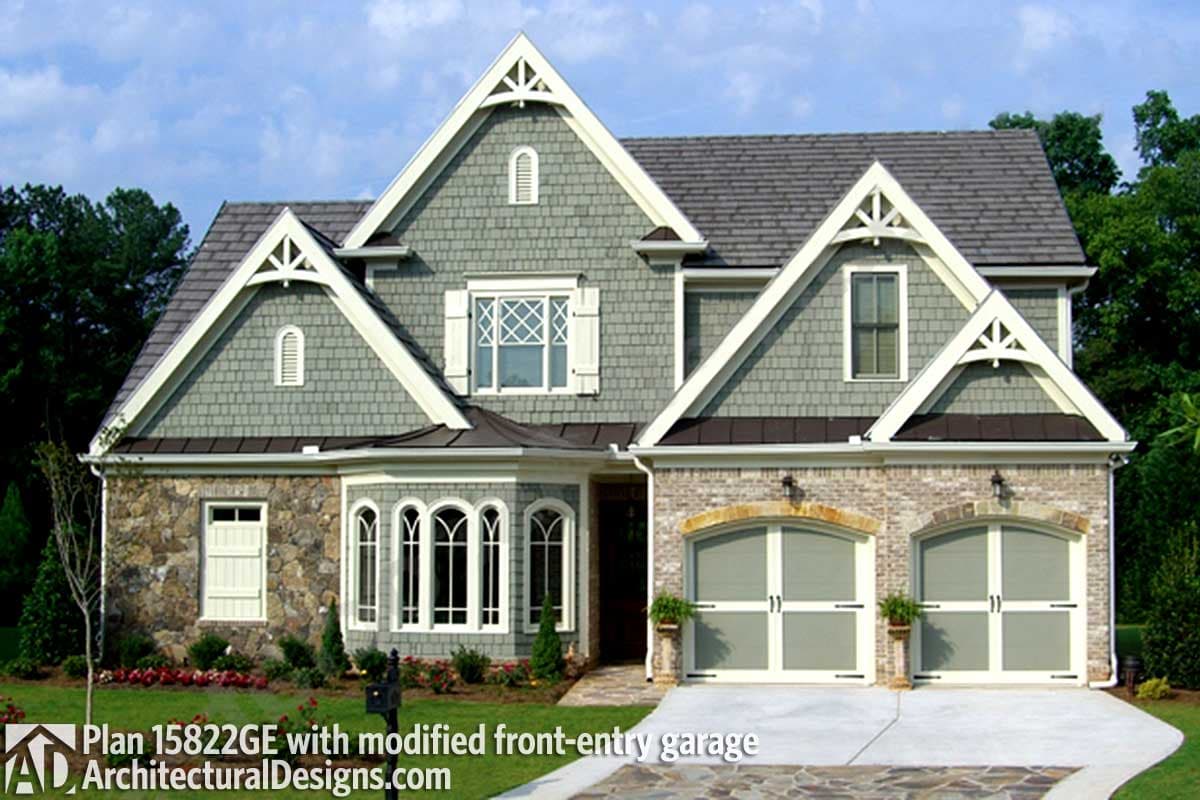 House plan exterior: Craftsman style, two stories, stone and shingle siding, gabled dormers, and dual front-entry garage.