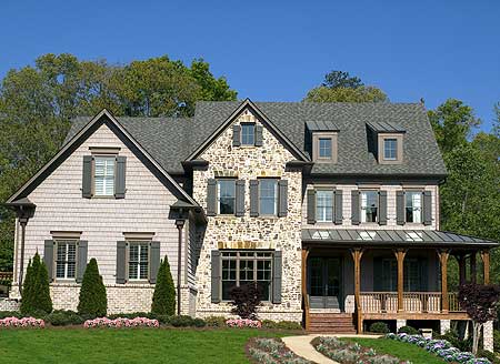 Two-story house plan exterior with stone and shingle siding, multiple gables, dormers, and a covered front porch.