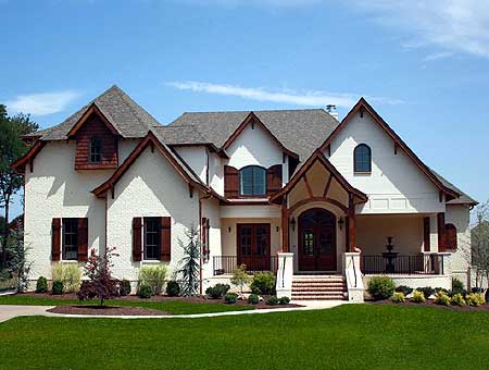 House plan exterior of a two-story home with multiple gables, a prominent arched entryway, and dormer windows.