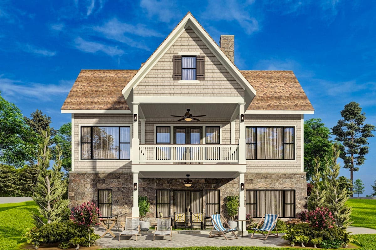 House plan exterior: Two-story home with stone and shingle siding, upper balcony, and prominent gable.