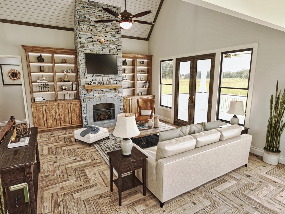 Great room with vaulted ceiling, stone fireplace, built-in cabinetry, and French doors leading to outdoor space.