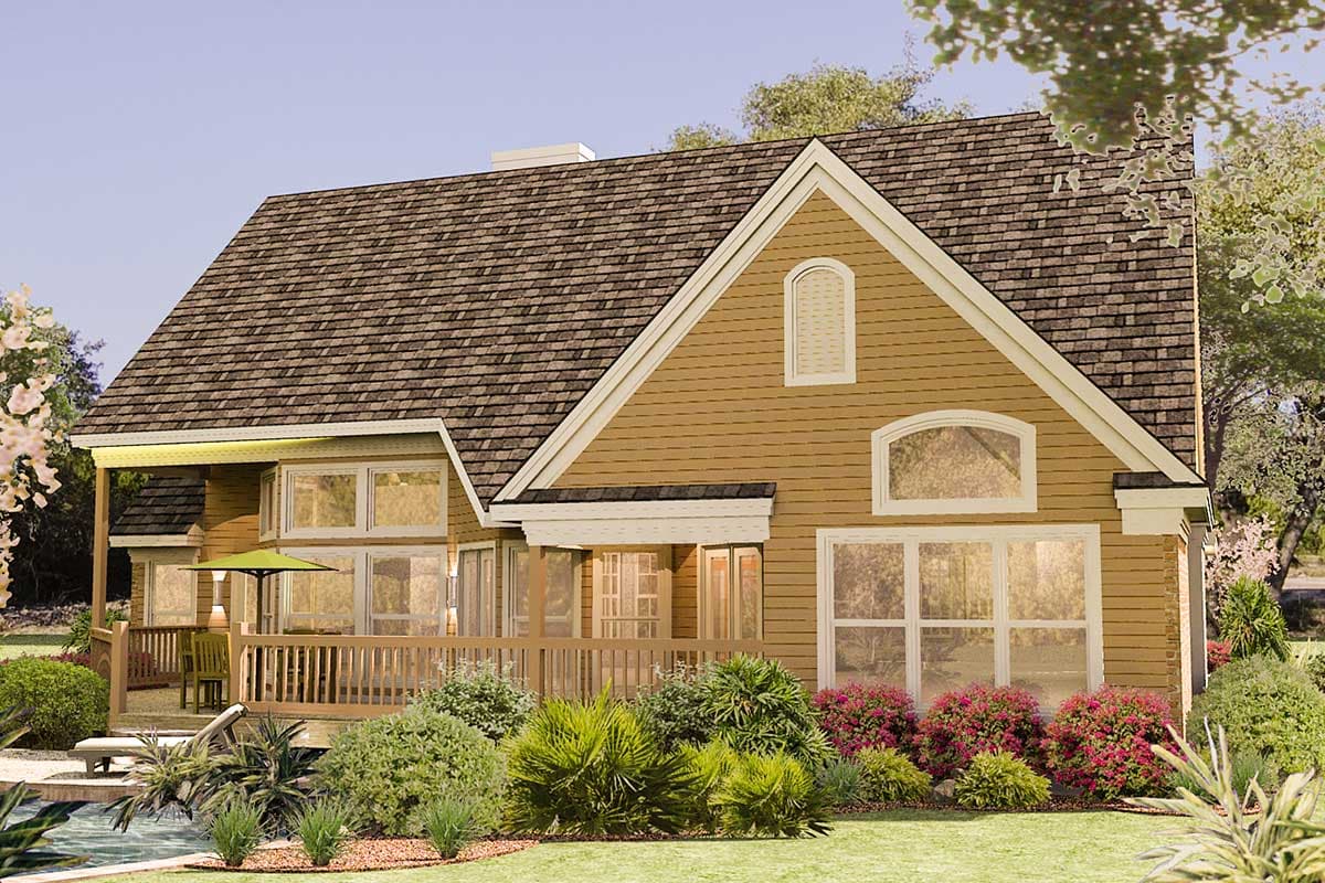 House plan exterior: Tan siding, multiple gables, large windows, and a wraparound porch.