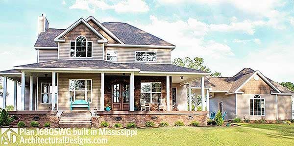 House plan exterior: Two-story Modern Farmhouse with wraparound porch, gables, arched dormer, and attached garage.