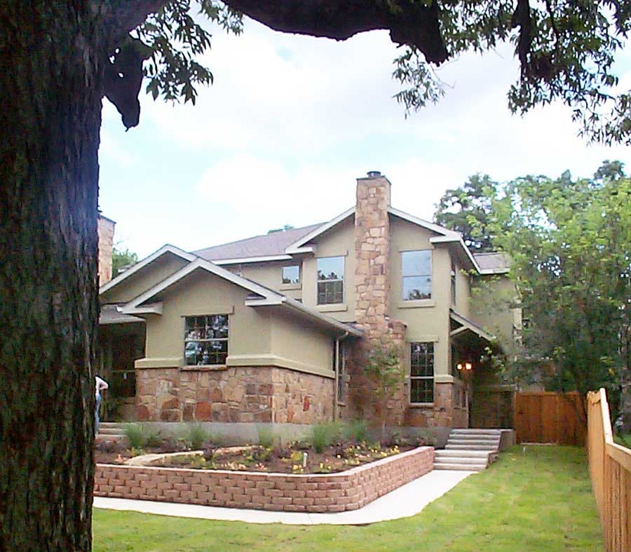House plan exterior, two stories, with stone base, large stone chimney, and multiple gables.