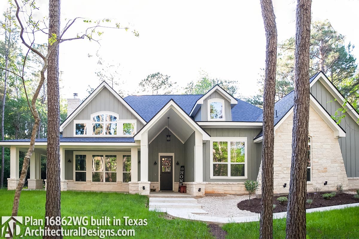 House plan exterior: Single-story Modern Farmhouse with stone accents, gabled rooflines, arched dormers, and a covered front porch.