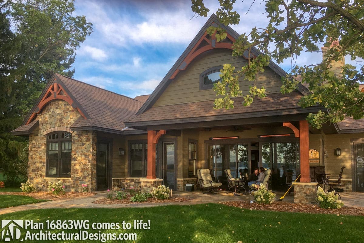 House plan exterior with stone and siding, covered porch with wood posts, and prominent gables with decorative bracing.