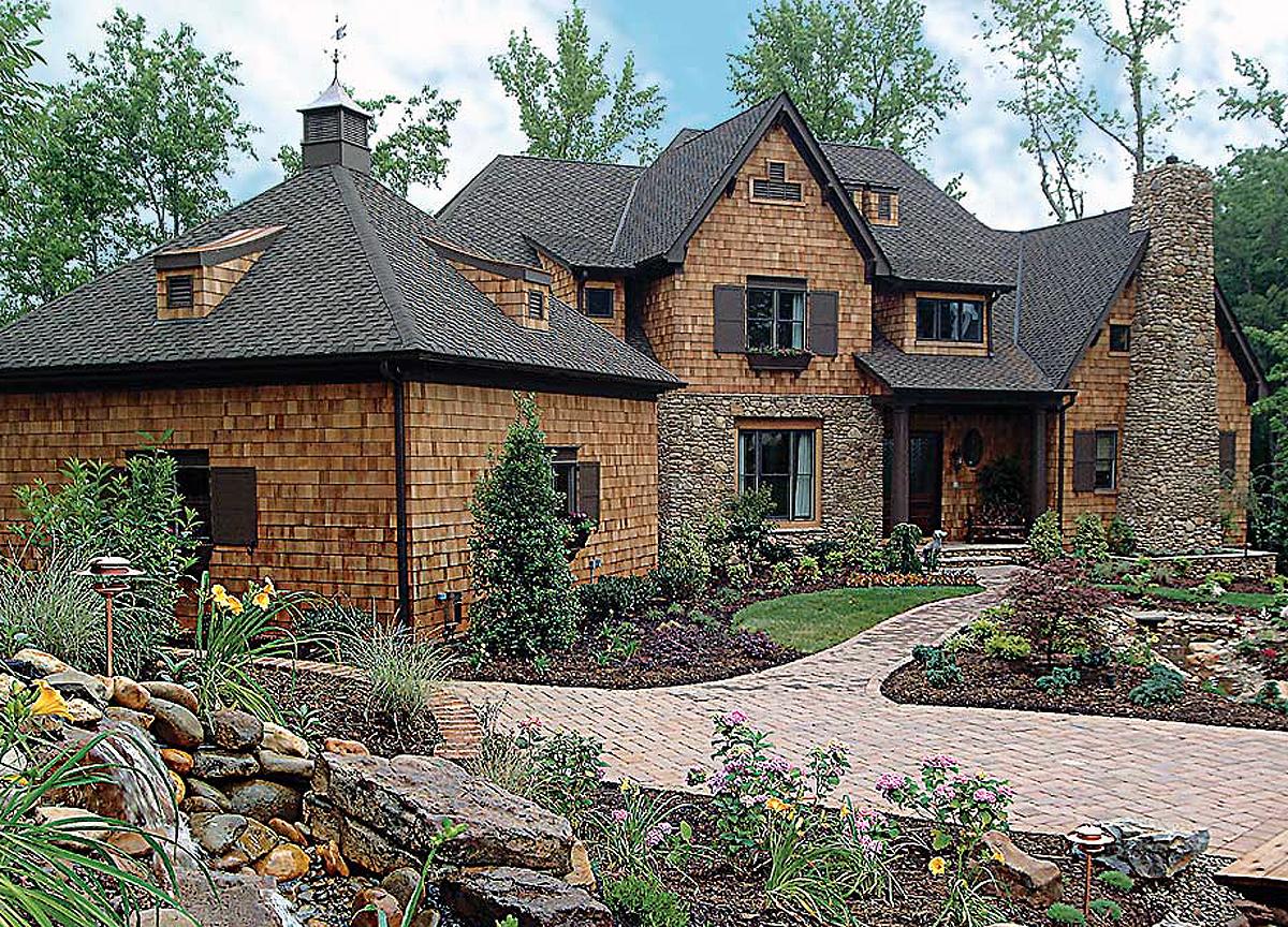 House plan exterior with cedar shingles, stone accents, dormers, cupola, gabled rooflines, and stone chimney.