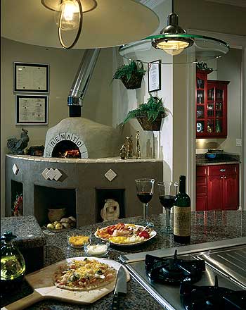 Kitchen with wood-fired pizza oven, granite countertops, and red cabinetry visible in background.