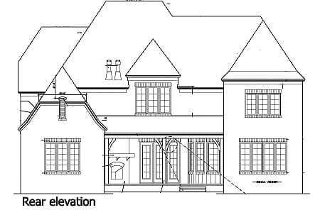 Rear elevation drawing of a house plan with a covered porch, multiple gables, and a turret.